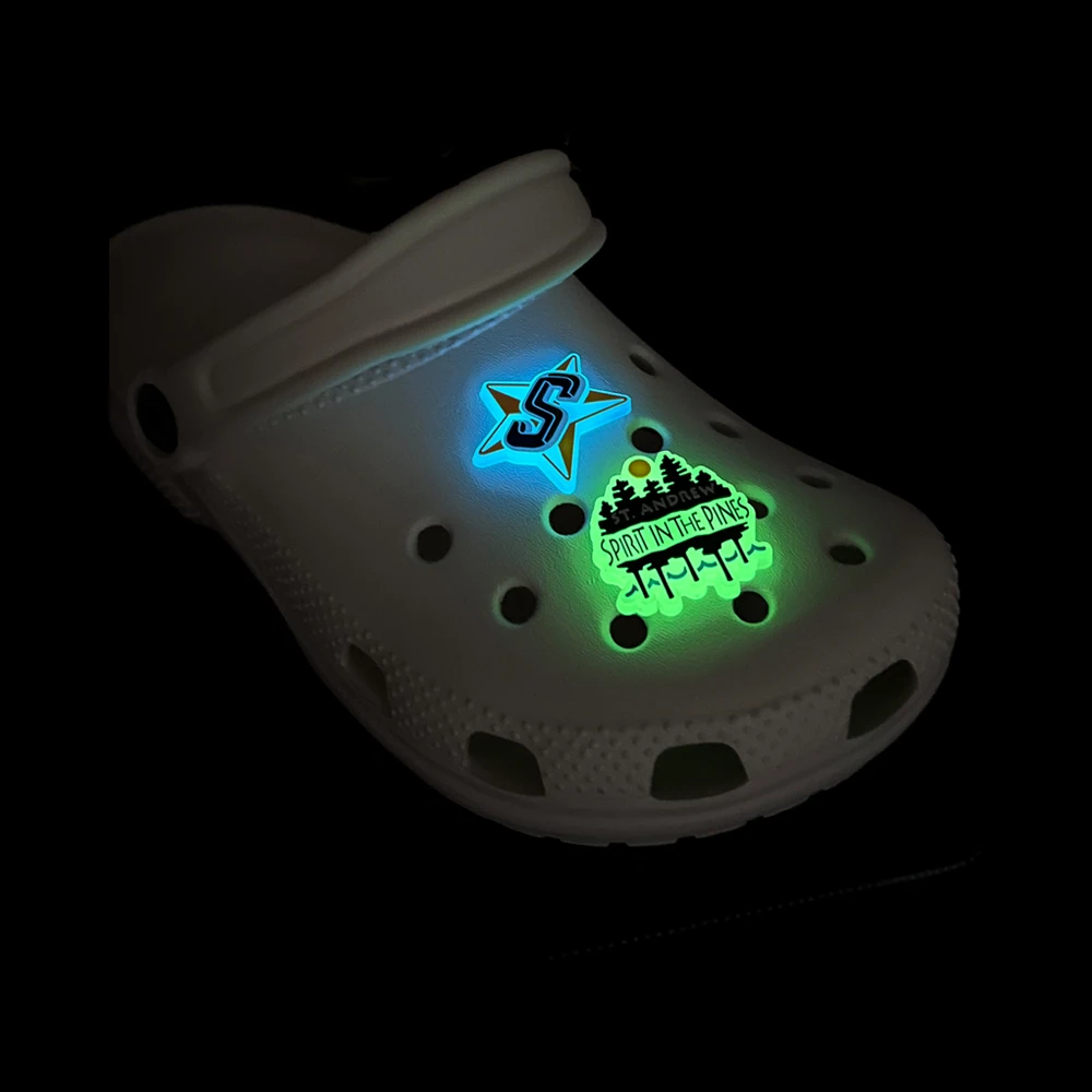 Glow-in-the-dark custom clog charms – star and Spirit in the Pines designs illuminated in the dark