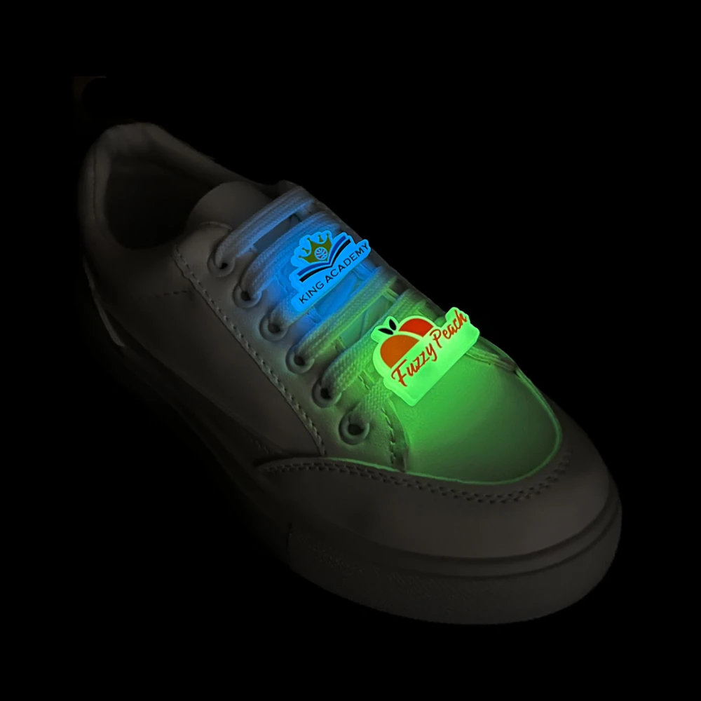 Glow-in-the-dark custom clip charms – King Academy and Fuzzy Peach designs illuminated in the dark