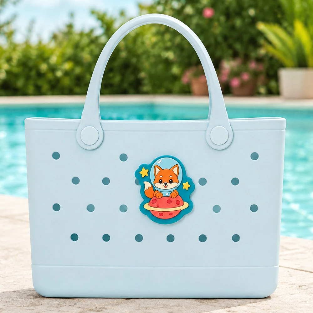 Custom soft PVC bag charm on a blue rubber tote by a swimming pool UK