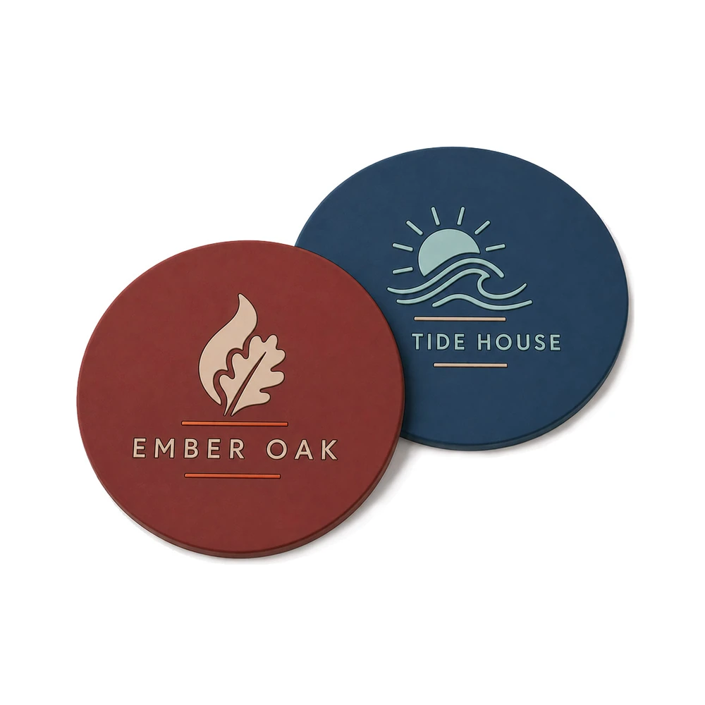 Two custom PVC rubber coasters showing Ember Oak and Tide House designs