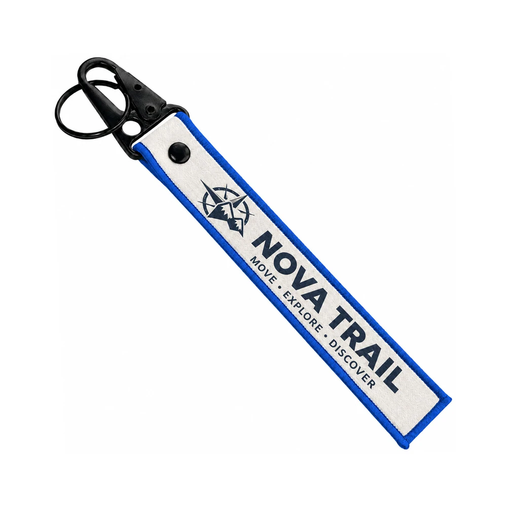 Custom woven flight-tag keychain — Nova Trail logo with black snap hook and split ring