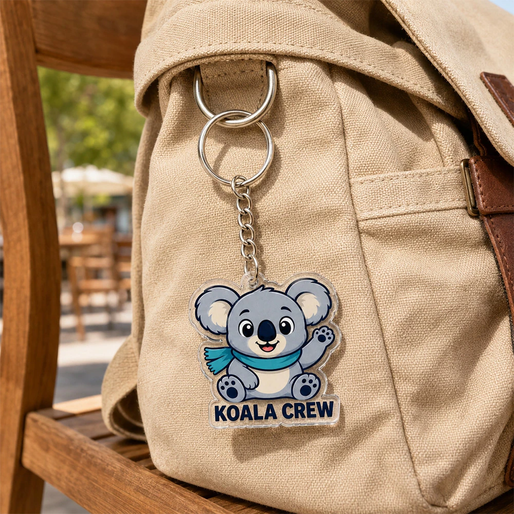 Koala crew die-cut acrylic keychain hanging on a canvas backpack outdoors Australia